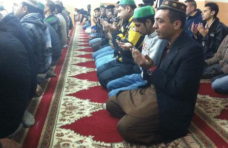 Muslims worship in an improvised prayer room in Athens