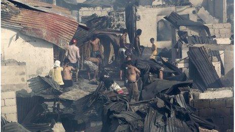 Residents return to their charred homes after fire razed some 500 houses at a residential area in San Juan City