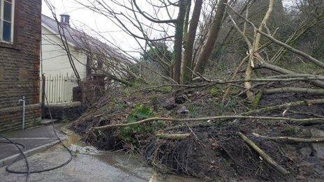 Trees fallen against the vestry of PanTteg Chapel in Ystalyfera after the landslip