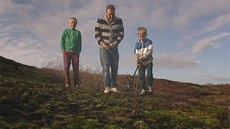 Sonny Carter (right) with his metal detector and brother Marley (left) and father Jem (centre)