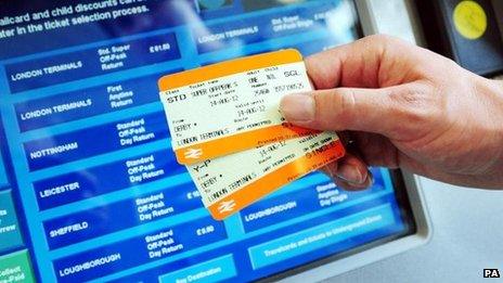 Rail tickets held out in front of ticket machine