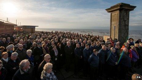 People attend the memorial service in Gynn Square, Blackpool