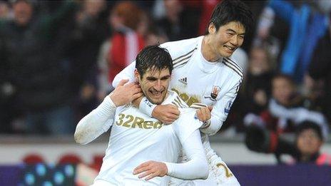 Danny Graham of Swansea City celebrates scoring the equalising goal against Arsenal with Ki Sung-Yueng