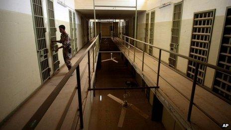 An Iraqi army soldier closes the door of a cell in Abu Ghraib prison 2 September 2006