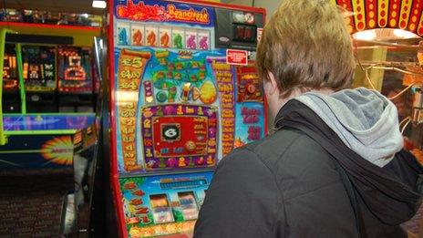 Person playing fruit machine