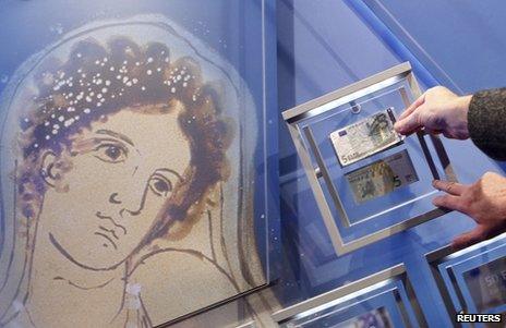 A portrait of Europa is seen next to new and old five-euro notes in Frankfurt, 10 January