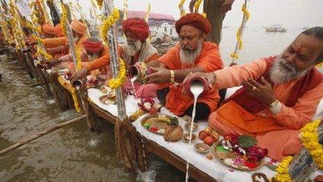 Hindu holy men offer prayers to the River Ganges ahead of the Maha Kumbh festival in Allahabad, India Sunday, Dec. 23, 2012.