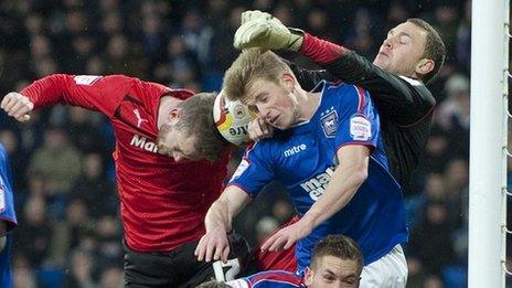 Cardiff City's Aron Gunnarsson has a header blocked by the Ipswich defence
