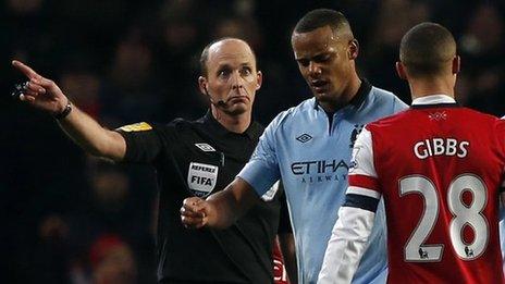 Vincent Kompany leaving the pitch after he was sent off by Mike Dean