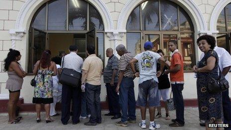 People queue up for passports in Havana