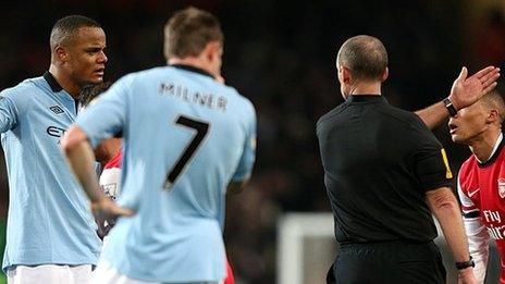 Manchester City captain Vincent Kompany (right) is sent off by referee Mike Dean