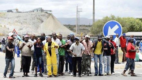 A group of miners gather outside an Anglo American Platinum shaft in Rustenberg