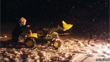 Child with digger in snow