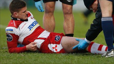 Freddie Burns receives treatment for his knee injury