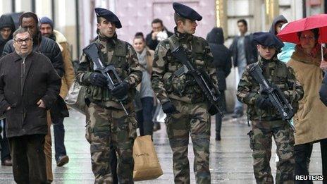 French soldiers patrol on the Champs Elysees avenue in Paris as part of the "Vigipirate" heightened security plan