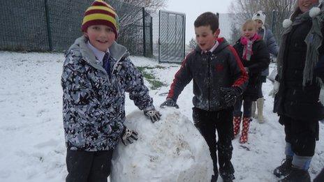 Children at St Marys RC Primary School build a snowman
