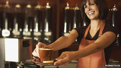 Barrista handing customer a coffee