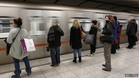 Passengers wait to board on a train at Syntagma metro station after the end of a nine-day strike in Athens, 25 January 2013