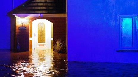 Floodwater surrounds a house in Llanddowror