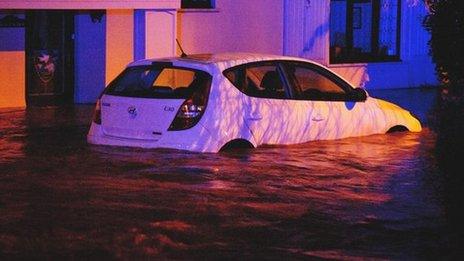 A car is surrounded by flooding in Llanddowror