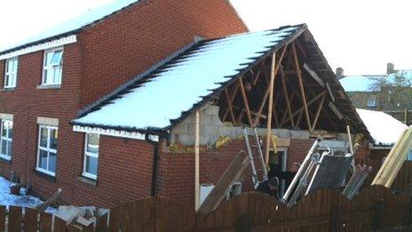 House with roof exposed after gable end collapsed