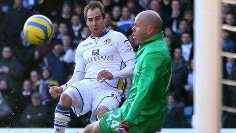 Luke Varney clips the ball past Brad Friedel to put Leeds ahead