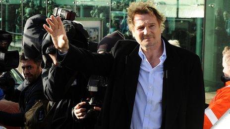 Liam Neeson waving