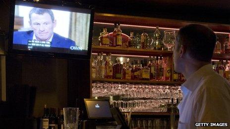 Man watches Lance Armstrong's Oprah interview in a bar