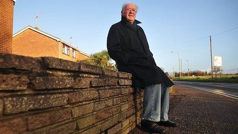 Harry Francis sitting at the spot where he and his family were brought to safety