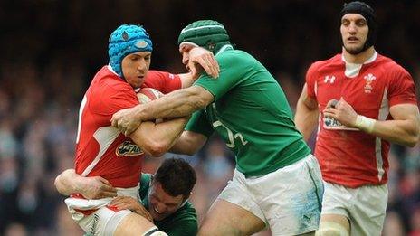 Justin Tipuric is stopped by Ireland tacklers as fellow Wales back-row Sam Warburton looks on