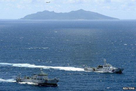 An aerial photo shows the Chinese marine surveillance ship Haijian No. 51 (L) cruising as a Japan Coast Guard ship Ishigaki sails near Uotsuri island, one of the disputed islands, called Senkaku in Japan and Diaoyu in China, in the East China Sea in this file photograph from 14 September 2012