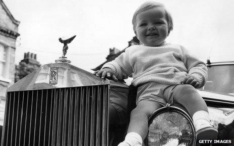 Baby sitting on a Rolls Royce