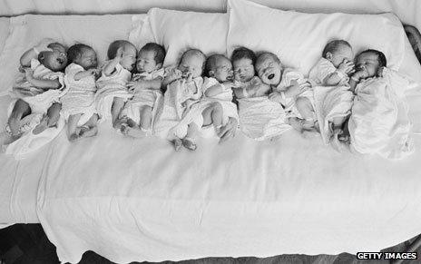 10 babies on a bed