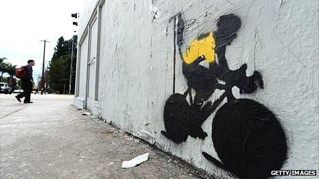 Los Angeles graffiti depicting a cyclist in a yellow jersey, the traditional garb of a Tour de France winner, attached to an IV drip. Lance Armstrong was stripped of 7 TDF titles