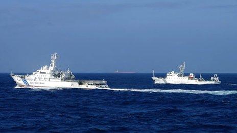 Japan's coast guard ship (left) sails along China's marine surveillance near the disputed islands in the East China Sea. File photo