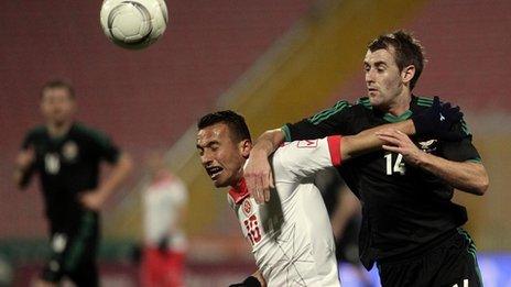 Malta's Andrew Cohen in action against Niall McGinn of Northern Ireland