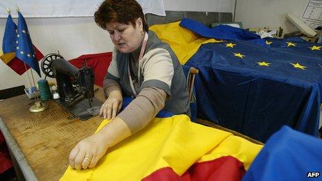 Worker sews Romanian flag in Bucharest (file image)