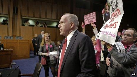 Protesters disrupt a US Senate confirmation hearing for John Brennan (centre) on 7 February 2013