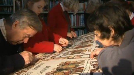 People working on the tapestry