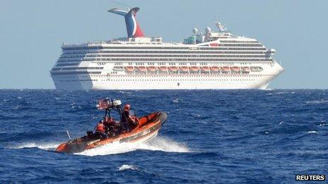 A small boat from the US Coast Guard Cutter Vigorous patrols near the cruise ship Carnival Triumph in the Gulf of Mexico, 11 February 2013