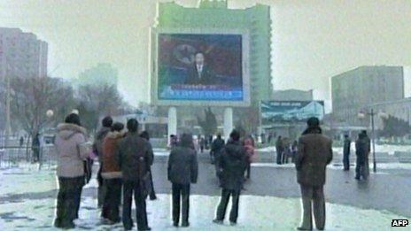 Screen grab from North Korean TV showing television announcement of nuclear test to people at Pyongyang's railway station on 12/2/13