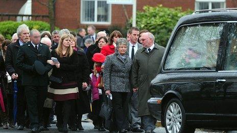 Mourners follow hearse