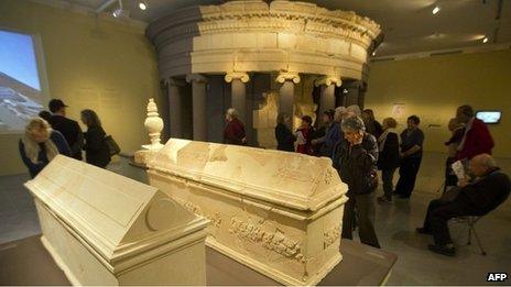 Visitors examine sarcophagi and what is believed to be the burial place of Herod brought from Herodium