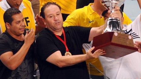 Nabil Maaloul (C) holds the Tunisian cup aloft