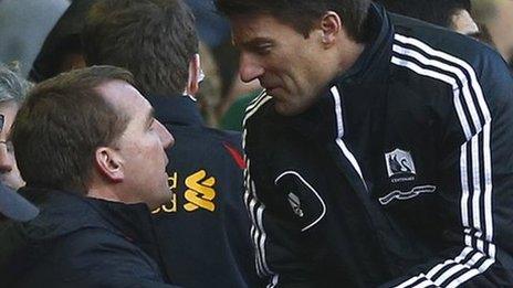 Manager Michael Laudrup (right) congratulates Liverpool boss Brendan Rodgers, his predecessor at Swansea, after the 5-0 loss at Anfield