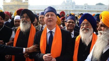 British Prime Minister David Cameron (C) along with Punjab State Chief Minister Parkash Singh Badal (2L), and Shiromani Gurdwara Parbandhak Committee (SGPC) President Avtar Singh Makkar (2R) visit the Sikh Shrine Golden temple in Amritsar on February 20, 2013.