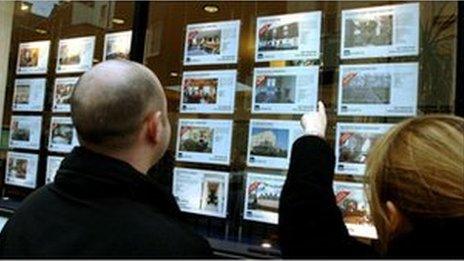 Couple at estate agent's window