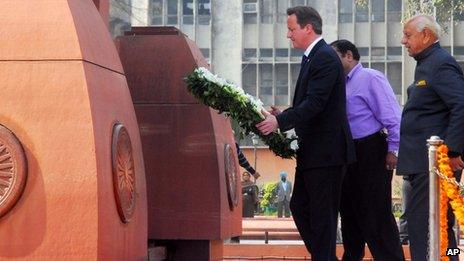 British Prime Minister David Cameron walks to lay a wreath at the site of a notorious 1919 massacre of hundreds of Indians by British colonial forces, in Amritsar, India, Wednesday, Feb. 20, 2013