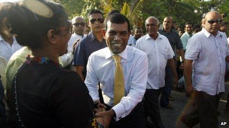 Former Maldives President Mohamed Nasheed, centre, shakes hands with a supporter after stepping out of the Indian High Commission in Male, Maldives, on Saturday