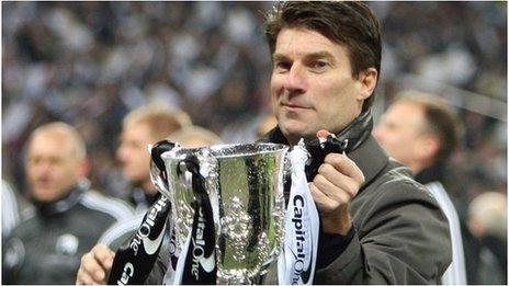 Swansea City manager Michael Laudrup lifts the Capital One Cup